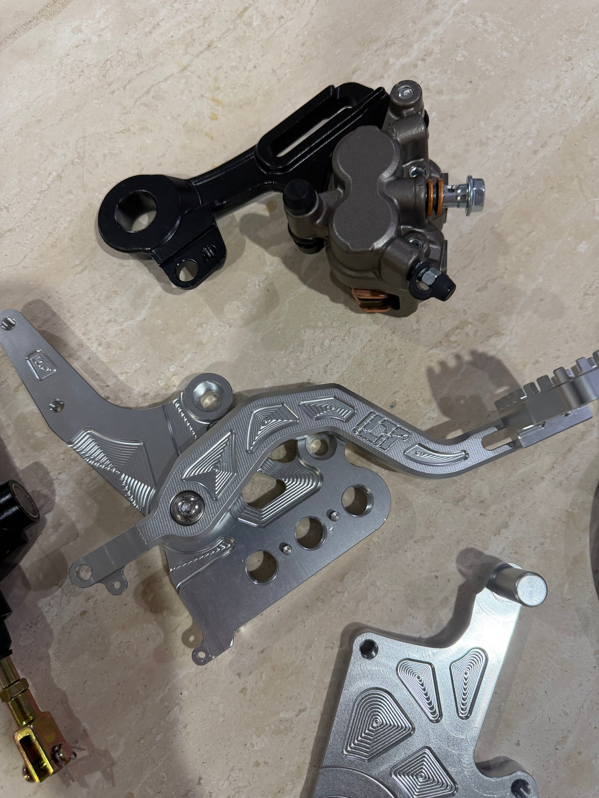 E-moto foot brake kit showing caliper, pedal assembly and mounting hardware from above