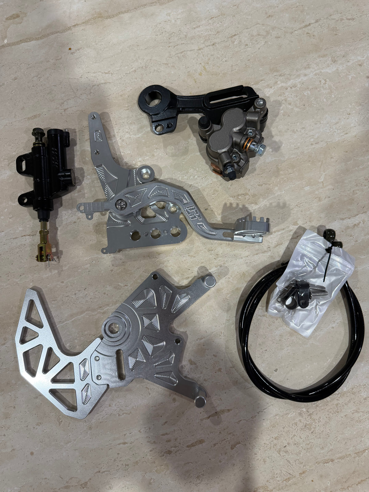 E-moto foot brake kit with caliper, master cylinder, machined bracket, rotor guard and brake line