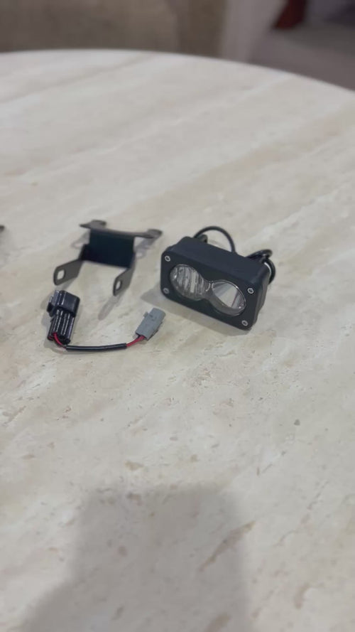 Baja LED auxiliary light kit with light unit, mounting brackets and wiring harness laid out
