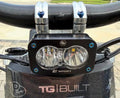 Baja Designs light fitted with a set of four blue titanium bolts on e-moto handlebars