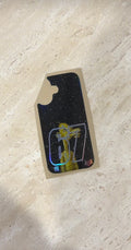 Neegy phone case decal in black with small character graphic shown on backing sheet