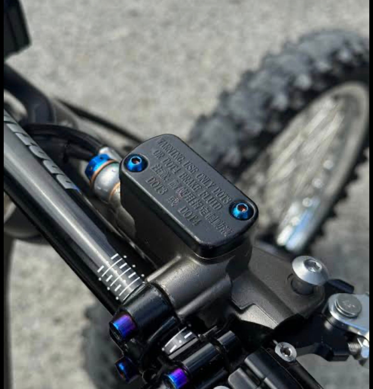 Titanium brake fluid cap bolts fitted to an Ultra Bee master cylinder reservoir, installed detail