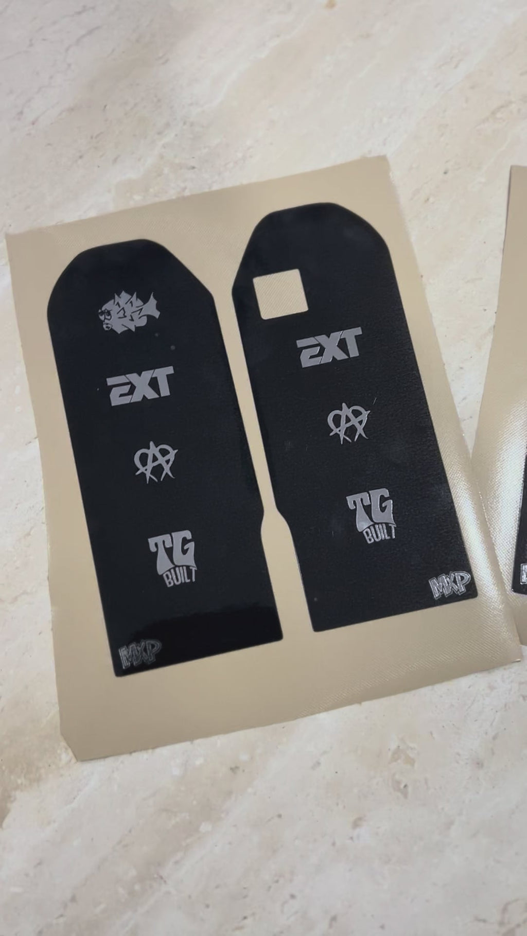 Talaria X3 fork decal pair in black with EXT and TG Built logos on backing sheet