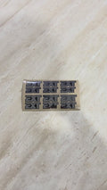 Sheet of mini EXT stickers in silver and black, twelve small decals on backing paper